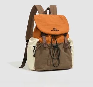 Detail of multi-color nylon backpack featuring drawstring closure and padded shoulder straps