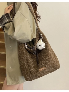 Brown fluffy faux fur tote bag with drawstring closure and cute plush ball charm