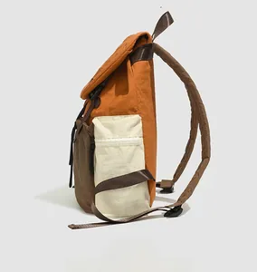 Side view of lightweight waterproof nylon backpack in orange, cream white and dark brown