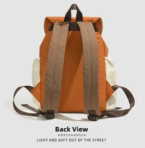 Detailed back view of an orange and brown lightweight travel backpack with wide straps
