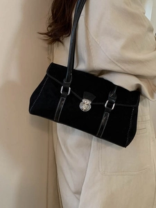 Large black suede hobo bag with contrast stitching and silver buckle on beige trench coat