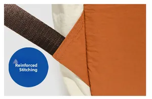Detail of bartack reinforcement on orange and beige nylon backpack straps for durability
