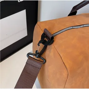 Detailed close-up of the durable swivel hook and strap attachment on the brown travel bag