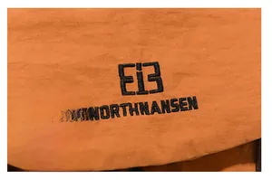 Detail of orange tear-resistant nylon fabric with black EiB NORTHNANSEN embroidery