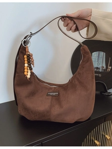 Brown faux suede crossbody dumpling bag with vintage style and colorful beaded tassel