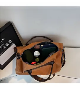 Detail view of large travel duffel bag showing spacious interior with multiple storage compartments