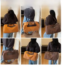 Detail view of large travel bag with leather handles shown in brown and ginger colors