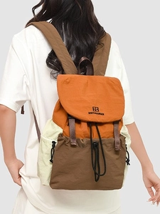 Three-color patchwork outdoor backpack in orange and beige with metallic buckles
