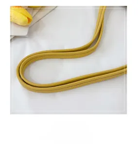 Detail of yellow faux leather handles with fine stitching for the shoulder tote bag