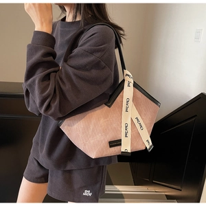 Detail of pink corduroy tote bag with black trim and Chia'2nd decorative ribbon