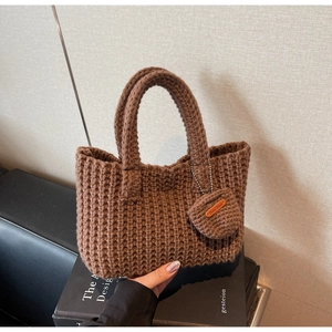 Detail of brown hand-knitted tote bag with macro texture and Hand Made tag
