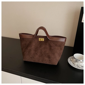 Close-up of vintage dark brown faux suede tote with rhombus stitching and gold clasp