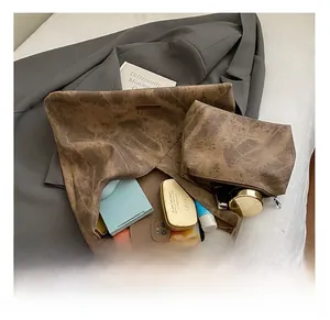 Close-up of the large brown suede tote bag with inner pouch showing spacious interior storage