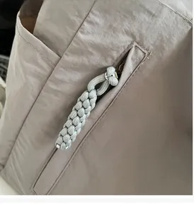 Detailed macro shot of the smooth hidden zipper and grey woven cord puller on a nylon tote