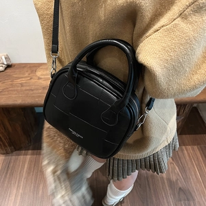 Retro black leather Boston handbag for women with checkered texture and crossbody strap