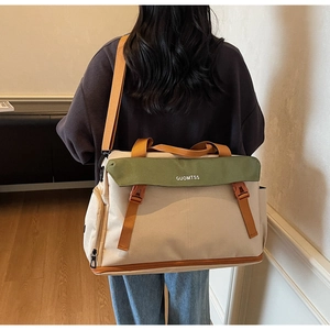Detail of multi-functional travel bag with orange straps and durable canvas texture
