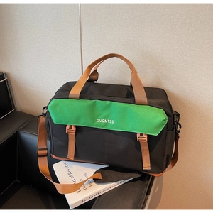 Detail view of large travel bag with green flap, nylon fabric and brown woven straps