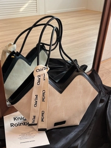 Fashionable oversized pleated tote bag in beige and black with decorative ribbon