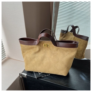 Detail of khaki suede tote bag with quilted stitching and gold twist-lock closure