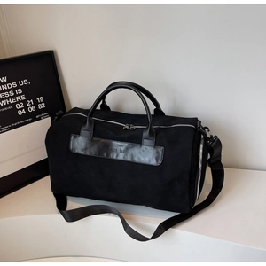 Detail of matte suede travel bag with MOCO BAG logo, dual zippers and leather handles