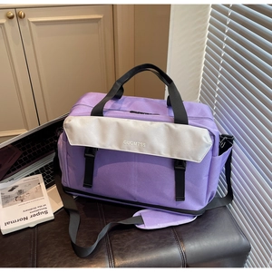 Macro detail of purple nylon travel bag with branded silver flap and adjustable strap