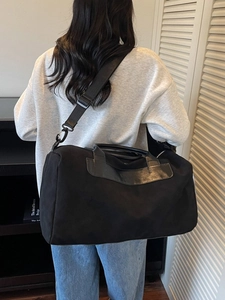 Large black travel bag with shoe compartment and adjustable shoulder strap for gym and sports