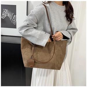 Close-up of coffee brown matte faux suede tote bag with smooth leather straps for women