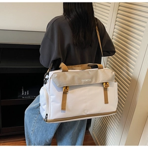 Detail of multi-functional travel bag with large capacity, buckles, and bottom compartment