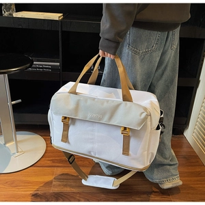 Detail view of large capacity travel bag with buckle closures and shoulder strap