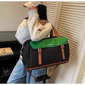 Model showing large green and black travel bag with adjustable strap in a home setting