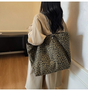Leopard print canvas tote bag styled with an elegant trench coat for daily autumn fashion