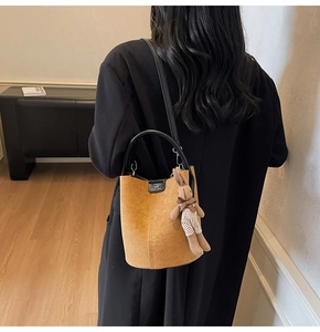 Frosted bucket bag in sandy yellow suede finish with DM logo and cute rabbit charm