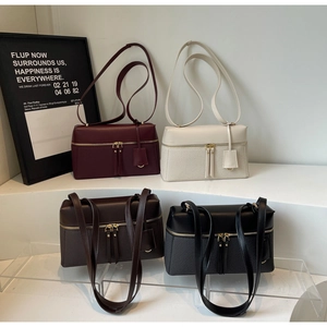 Detail of minimalist shoulder bags in four colors with leather and woven texture mix