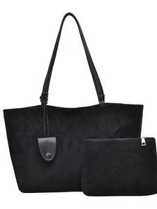 Matte black oversized tote bag with matching zippered pouch and minimalist pendant