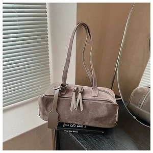 Detail of grey-brown frosted suede pillow bag with dual zippers and long shoulder straps