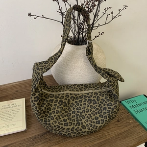 Detail view of leopard print hobo bag with adjustable strap and silver metal hardware