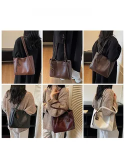 Multiple colors of large tote bags with woven shoulder straps shown on a model