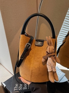 Retro brown suede bucket bag with black leather handle and cute bunny charm pendant