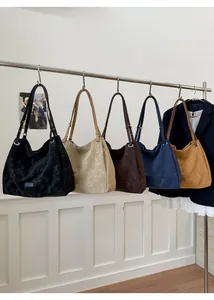 Macro shot of hobo style shoulder bags in five colors hanging on a metal clothing rack