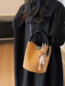 Brown frosted suede bucket bag with top handle and cute bunny charm accessory