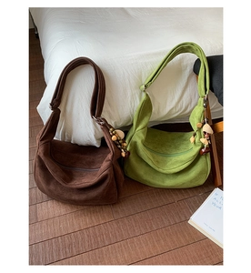Détail de sacs croissants en daim avec des breloques perlées de style bohème