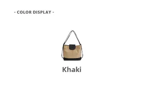 Detail view of khaki and black canvas shoulder bag with minimalist magnetic button closure