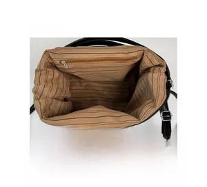 Close-up of tote bag interior featuring striped fabric lining and silver zipper pocket