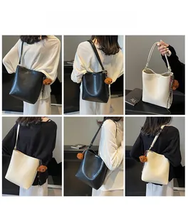 Detailed views of minimalist tote bucket bags in black and beige with cute bear charms