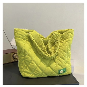 Detailed close-up of lime green quilted corduroy tote bag showing soft ribbed texture