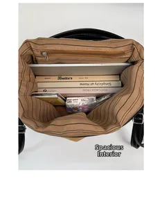 Top view of large black leather bag showing striped lining and laptop storage space