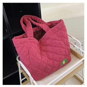 Detail of rose pink corduroy tote bag with quilted diamond pattern and MISU brand label