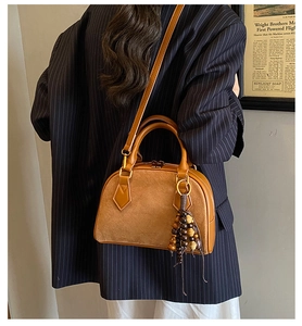 Brown pillow bag with suede texture and multi-colored wooden bead tassel pendant