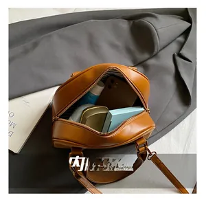 Internal capacity of brown shell bag showing space for phone and cosmetics