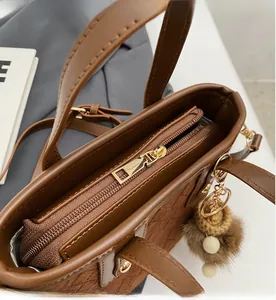 Close-up of golden zipper and textured brown leather on vintage bucket bag detail